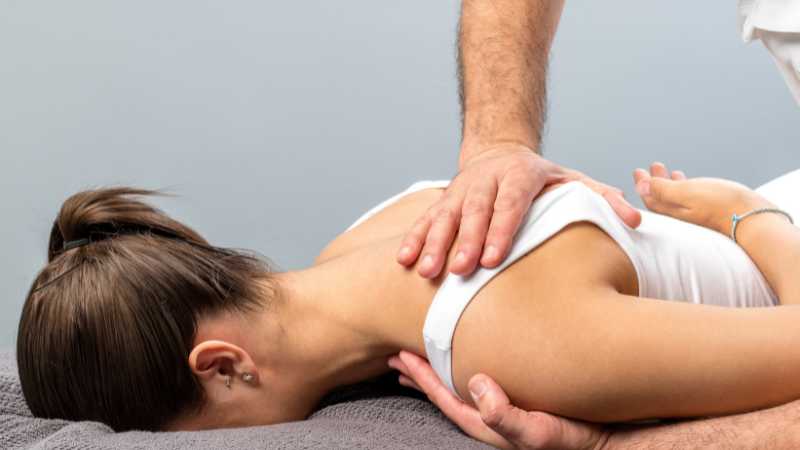 osteopath treating lady's shoulder