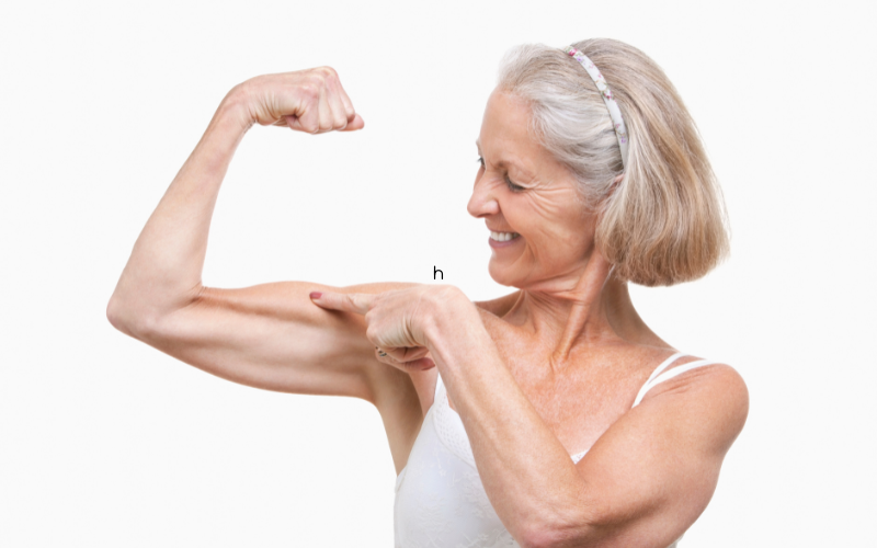 Postmenopausal women flexing her healthy biceps muscles