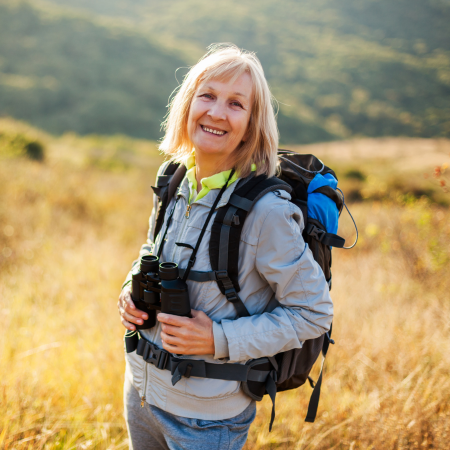 Happy lady hiking with no back pain